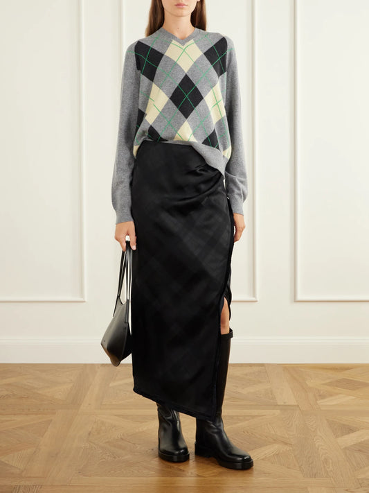 Image of a model wearing Skirts. Product name - The Alee Checked Frayed Asymmetric Satin Maxi Skirt in Black colour by brand - RÙADH