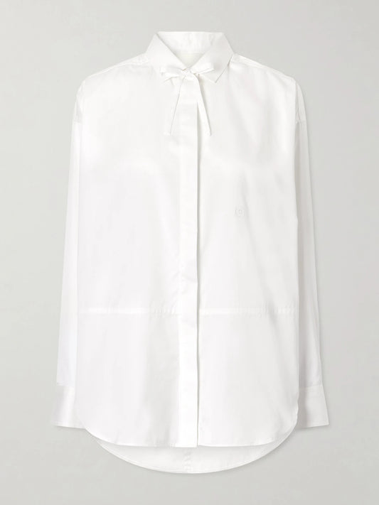 Image of a model wearing Tops. Product name - The Dune Tie-detailed Cotton-sateen Shirt in White colour by brand - RÙADH