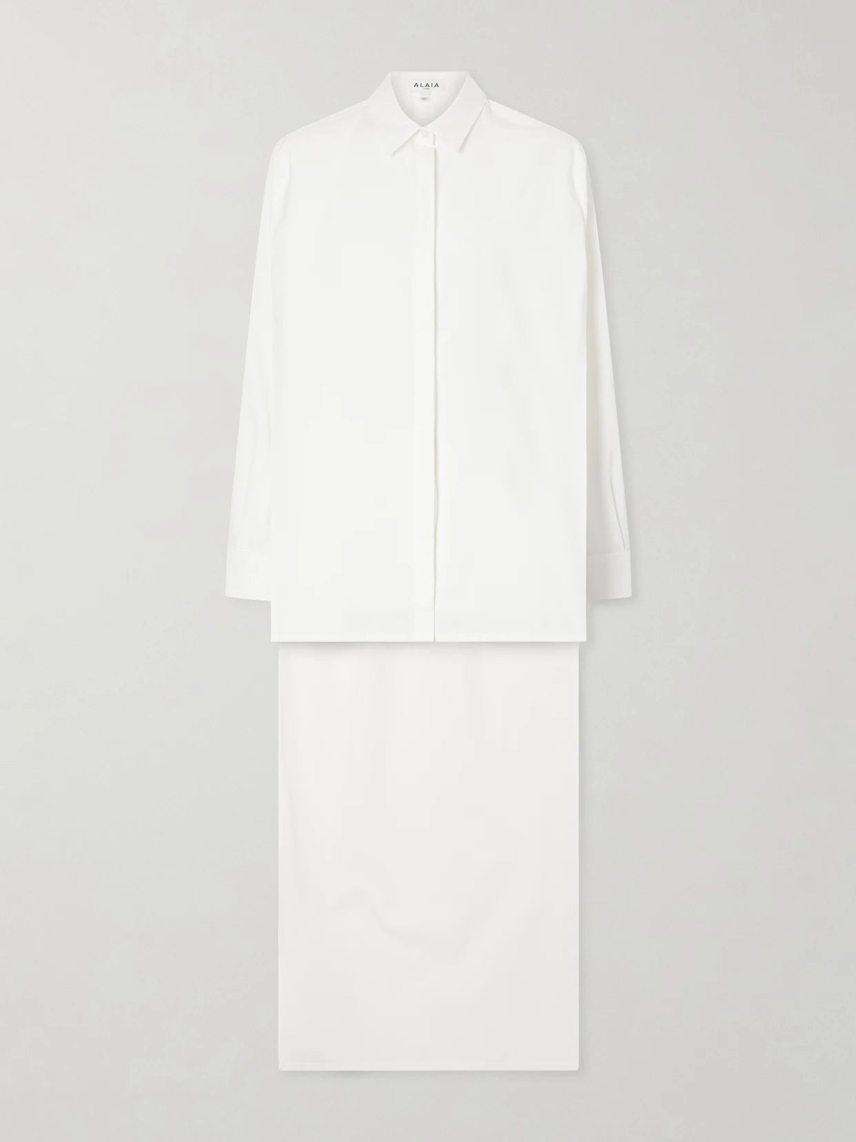 Image of a model wearing Tops. Product name - Asymmetric Cotton Poplin Shirt in White colour by brand - Alaïa