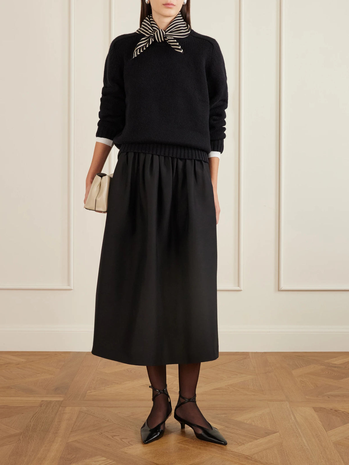 Image of a model wearing Skirts. Product name - Gathered Wool And Silk-blend Midi Skirt in Black colour by brand - TOTEME