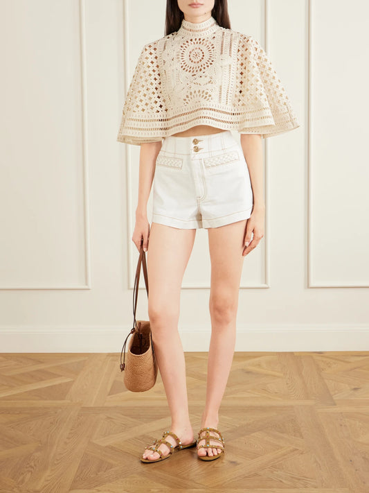 Image of a model wearing Tops. Product name - Indra Embroidered Cotton Cape in Cream colour by brand - Zimmermann