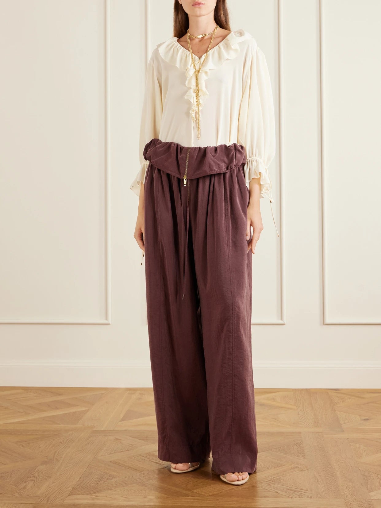 Image of a model wearing Pants. Product name - Silk-blend Wide-leg Pants in Dark purple colour by brand - Chloé