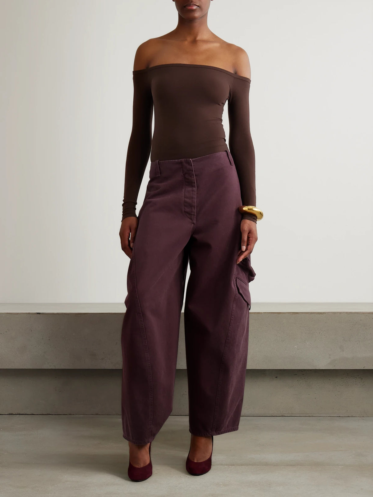 Image of a model wearing Tops. Product name - Off-the-shoulder Stretch-jersey Bodysuit in Brown colour by brand - Alaïa