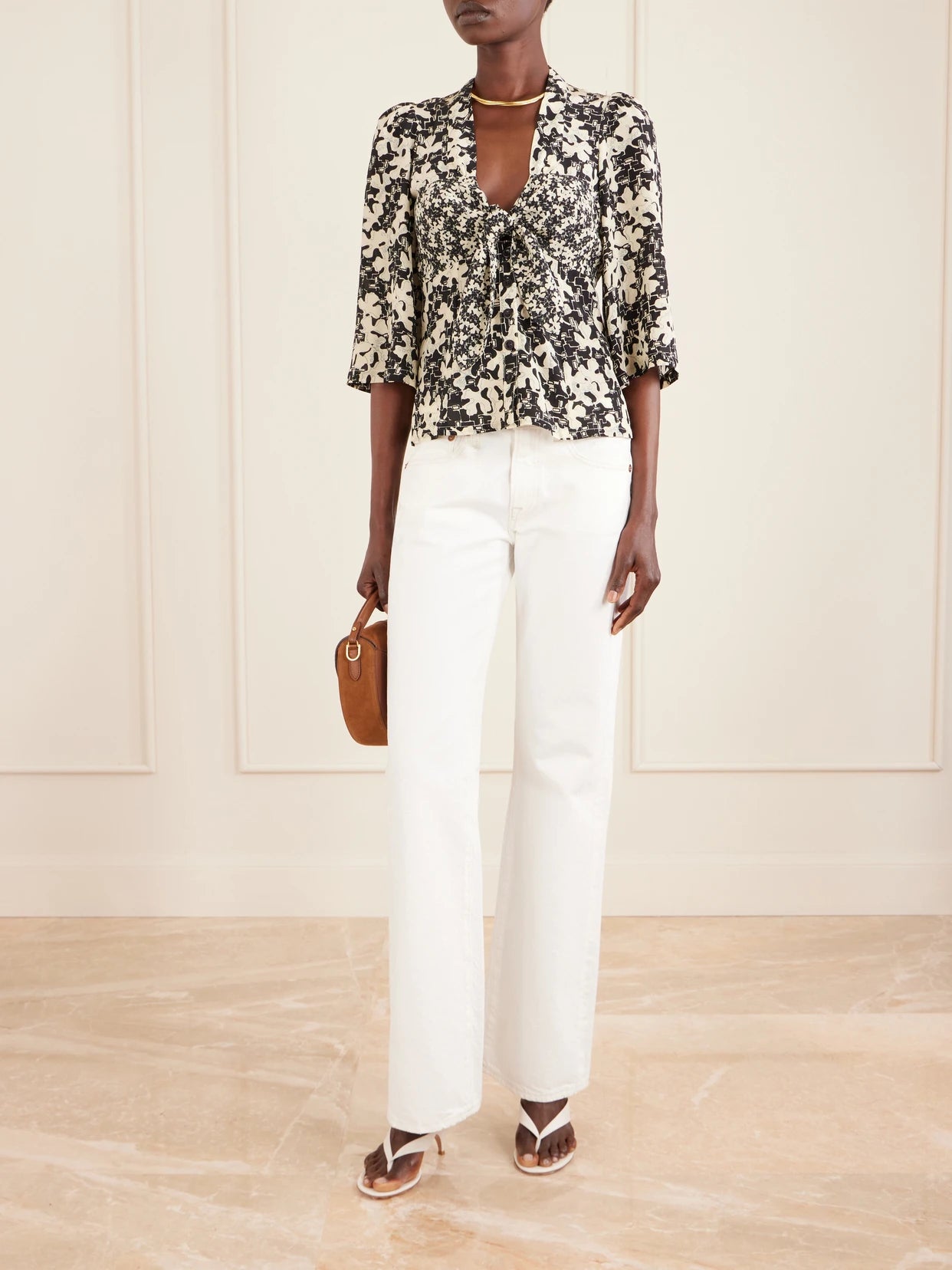 Image of a model wearing Tops. Product name - Kazu Floral-print Silk Top in Black colour by brand - MAISON MAYLE