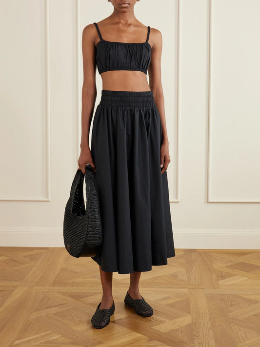 Image of a model wearing Tops. Product name - Bea Shirred Cotton-poplin Bandeau Tank in Black colour by brand - Suzie Kondi