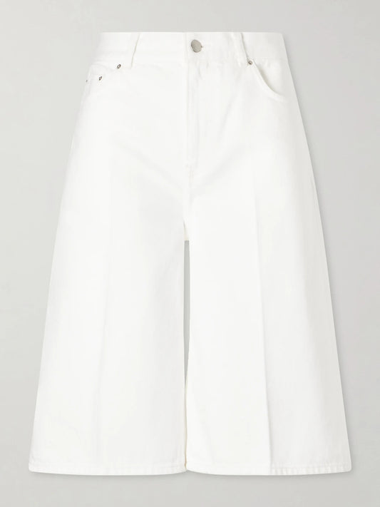 Image of a model wearing Shorts. Product name - Denim Wide-leg Shorts in White colour by brand - TOTEME