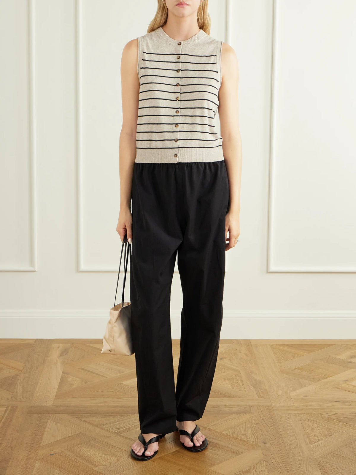 Image of a model wearing Outerwear. Product name - Lee Striped Knitted Vest in Tan colour by brand - La Ligne