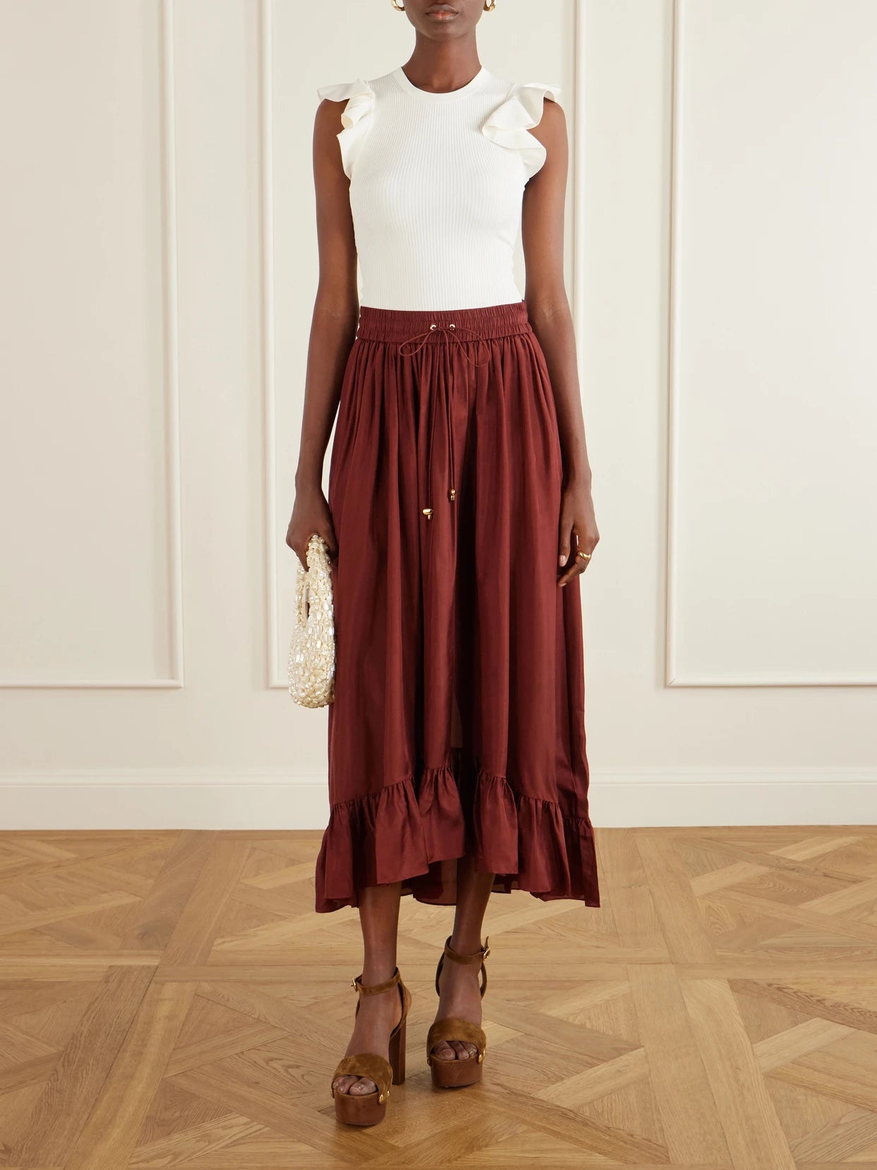 Image of a model wearing Tops. Product name - Aster Frill Racer Ribbed-knit Tank in White colour by brand - Zimmermann