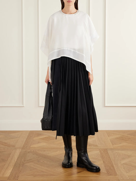 Image of a model wearing Skirts. Product name - Pleated Herringbone Wool-blend Midi Skirt in Black colour by brand - Sacai