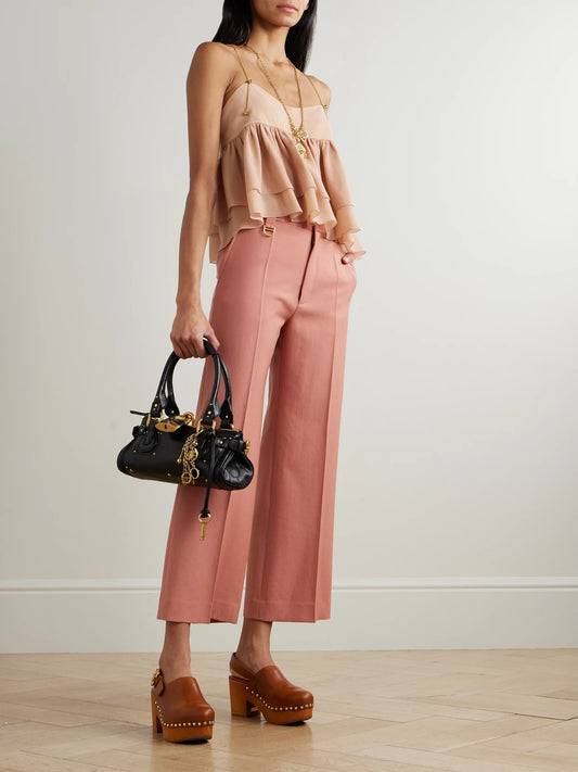 Image of a model wearing Pants. Product name - Cropped Wool-gabardine Wide-leg Pants in Pink colour by brand - Chloé
