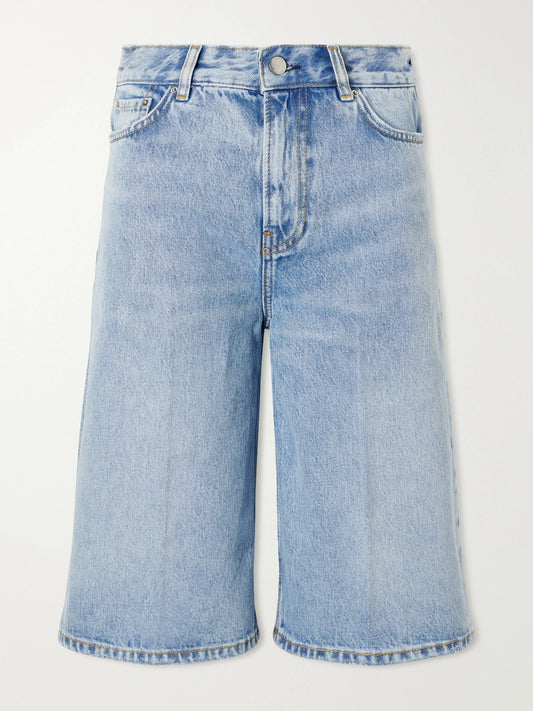 Image of a model wearing Shorts. Product name - Organic Denim Straight-leg Shorts in Mid denim colour by brand - TOTEME
