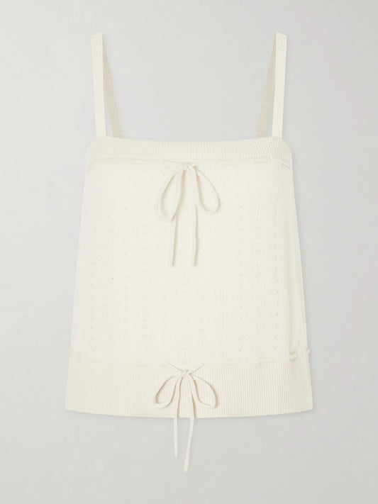 Image of a model wearing Tops. Product name - Charm Knotted Knit Cashmere Tank in Cream colour by brand - FRAME