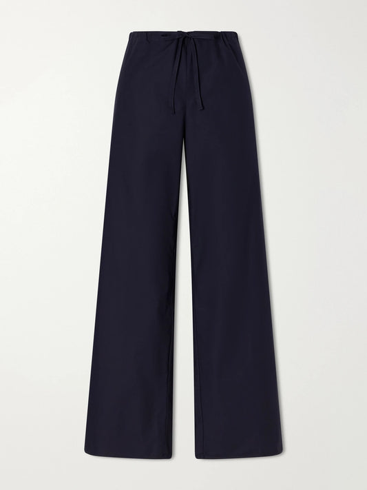 Image of a model wearing Pants. Product name - Josephine Drawstring Organic Cotton-poplin Straight-leg Pants in Navy colour by brand - FLORE FLORE