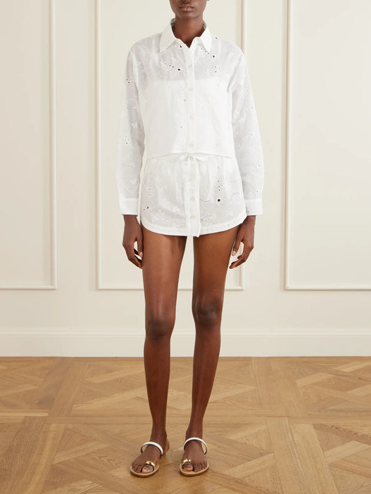 Image of a model wearing Skirts. Product name - Simone Broderie Anglaise Cotton Mini Skirt in Ivory colour by brand - Kiki de Montparnasse