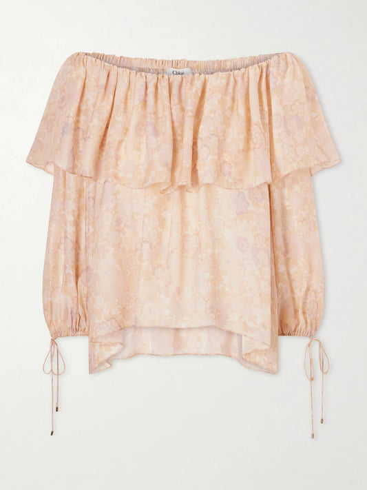 Image of a model wearing Tops. Product name - Off-the-shoulder Ruffled Floral-print Silk-charmeuse Blouse in Pink colour by brand - Chloé