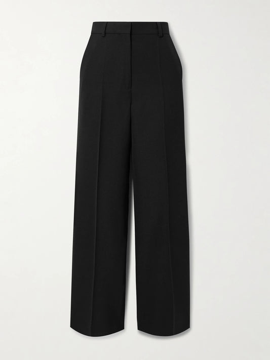 Image of a model wearing Pants. Product name - Recycled Grain De Poudre Straight-leg Pants in Black colour by brand - TOTEME