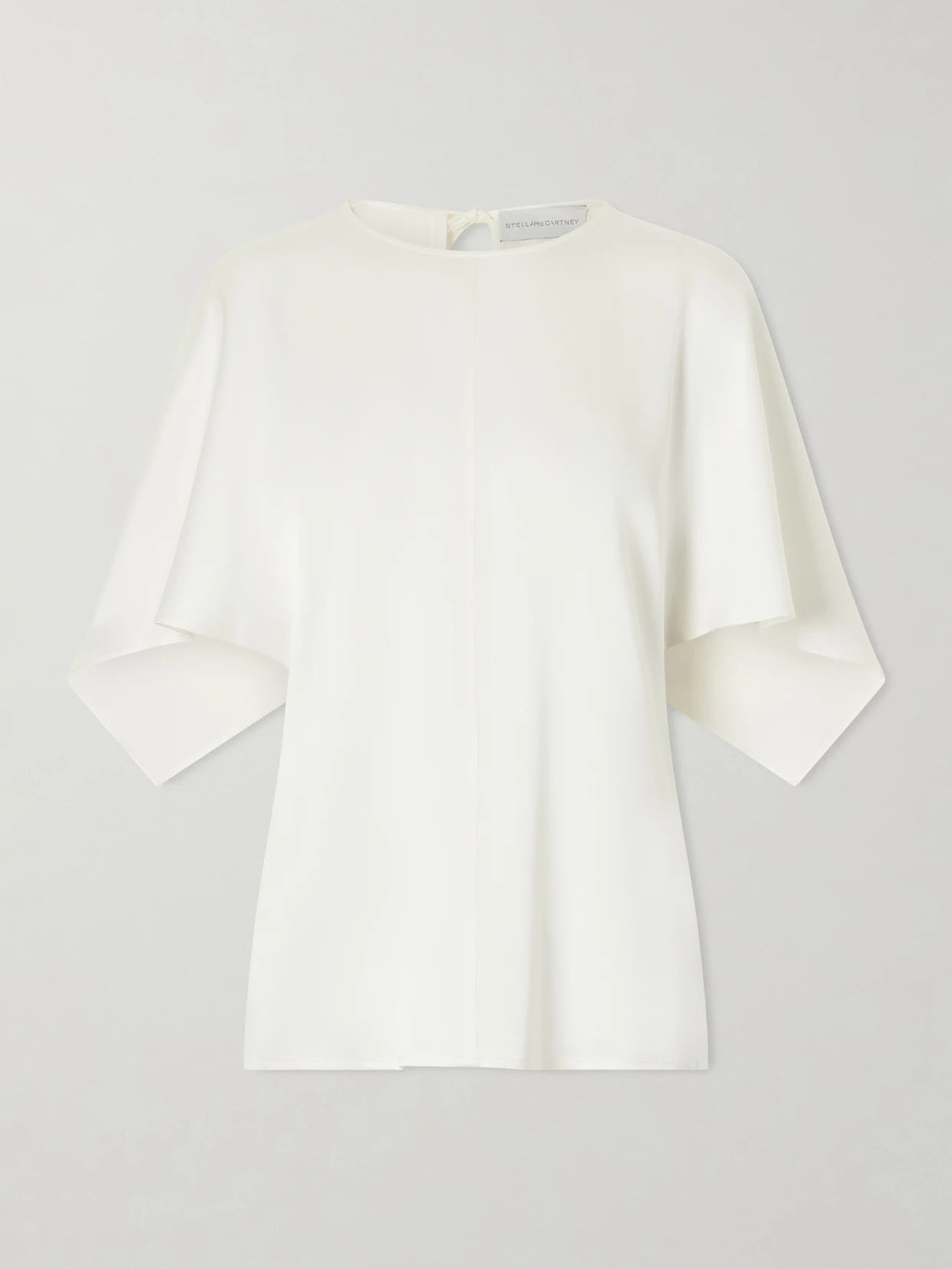 Image of a model wearing Tops. Product name - Open-back Satin Blouse in White colour by brand - Stella McCartney
