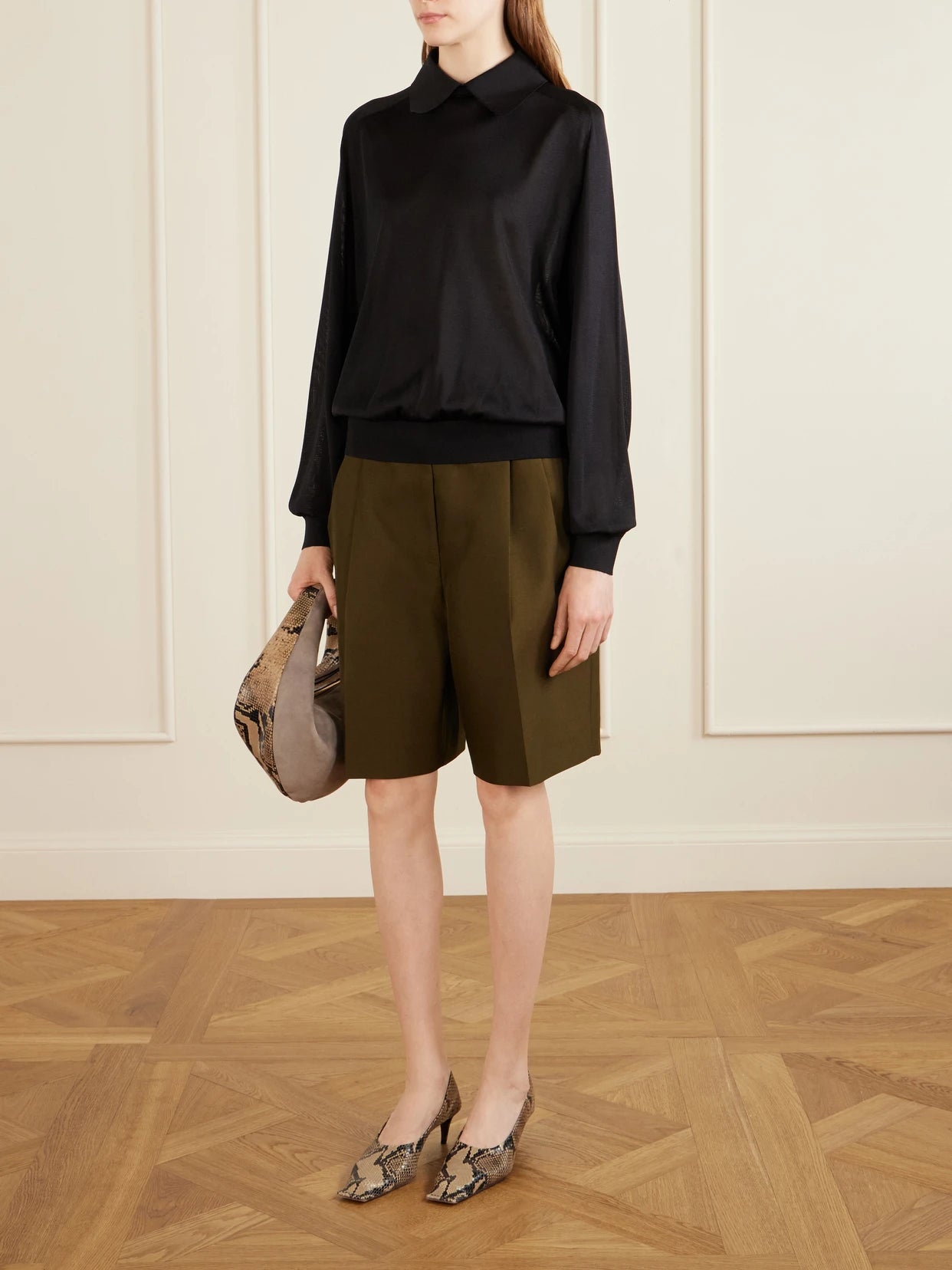 Image of a model wearing Shorts. Product name - Auggie Pleated Wool And Silk-blend Shorts in Army green colour by brand - KHAITE