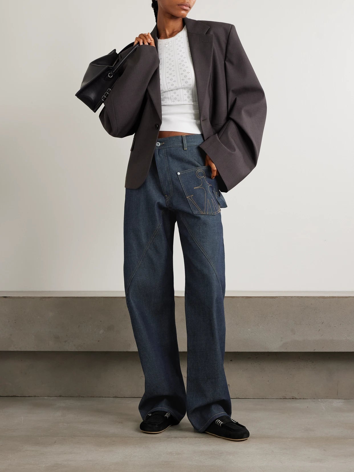 Image of Jeans. Product name - Twisted Asymmetric Embroidered High-rise Jeans in Indigo colour by brand - JW Anderson