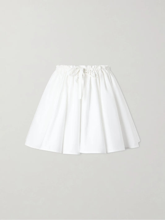 Image of a model wearing Skirts. Product name - Pleated Cotton Mini Skirt in White colour by brand - Givenchy