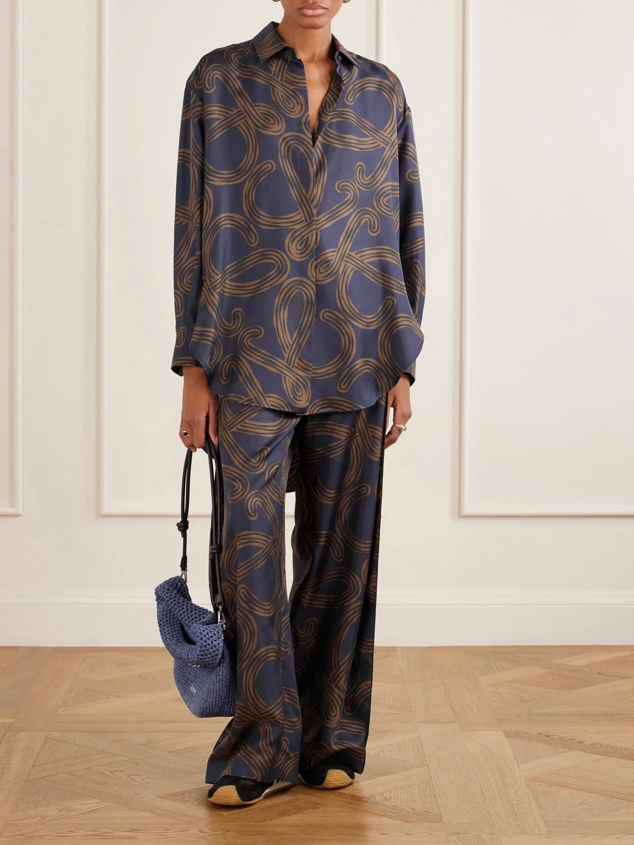 Image of a model wearing Tops. Product name - + Paula's Ibiza Anagram-printed Silk-twill Shirt in Navy colour by brand - LOEWE