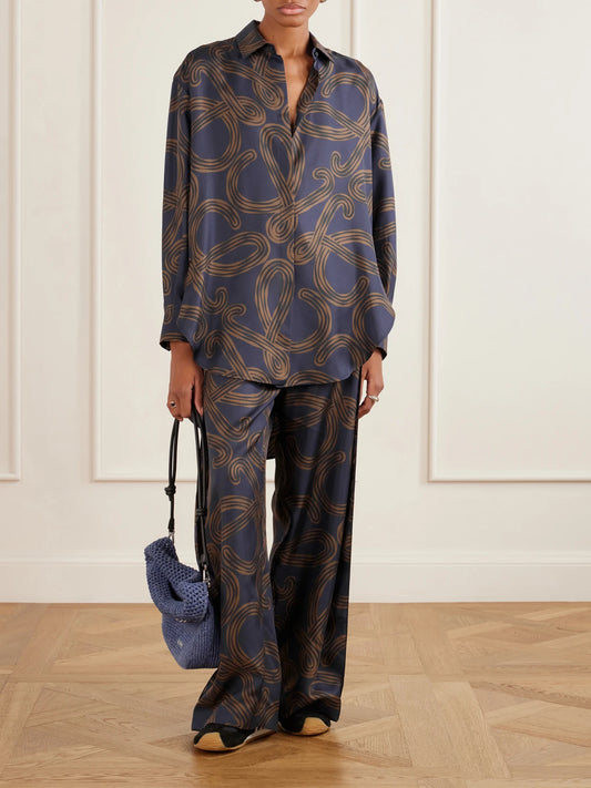Image of a model wearing Tops. Product name - + Paula's Ibiza Anagram-printed Silk-twill Shirt in Navy colour by brand - LOEWE