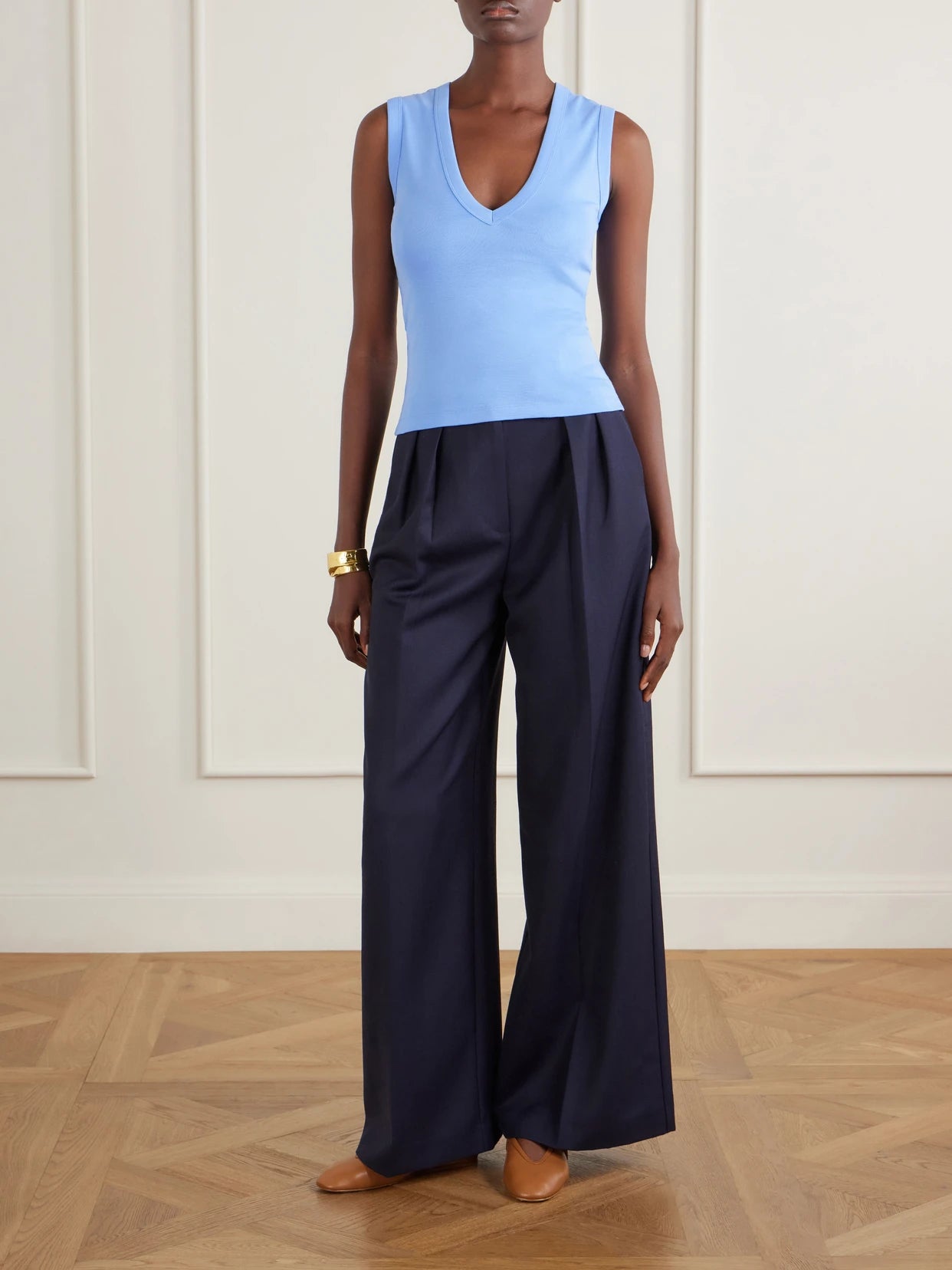 Image of a model wearing Tops. Product name - Dewi Organic Cotton Jersey Tank in Blue colour by brand - FLORE FLORE