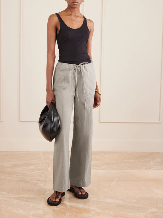 Image of a model wearing Pants. Product name - Seam Organic Cotton Straight-leg Drawstring Pants in Gray colour by brand - Deiji Studios