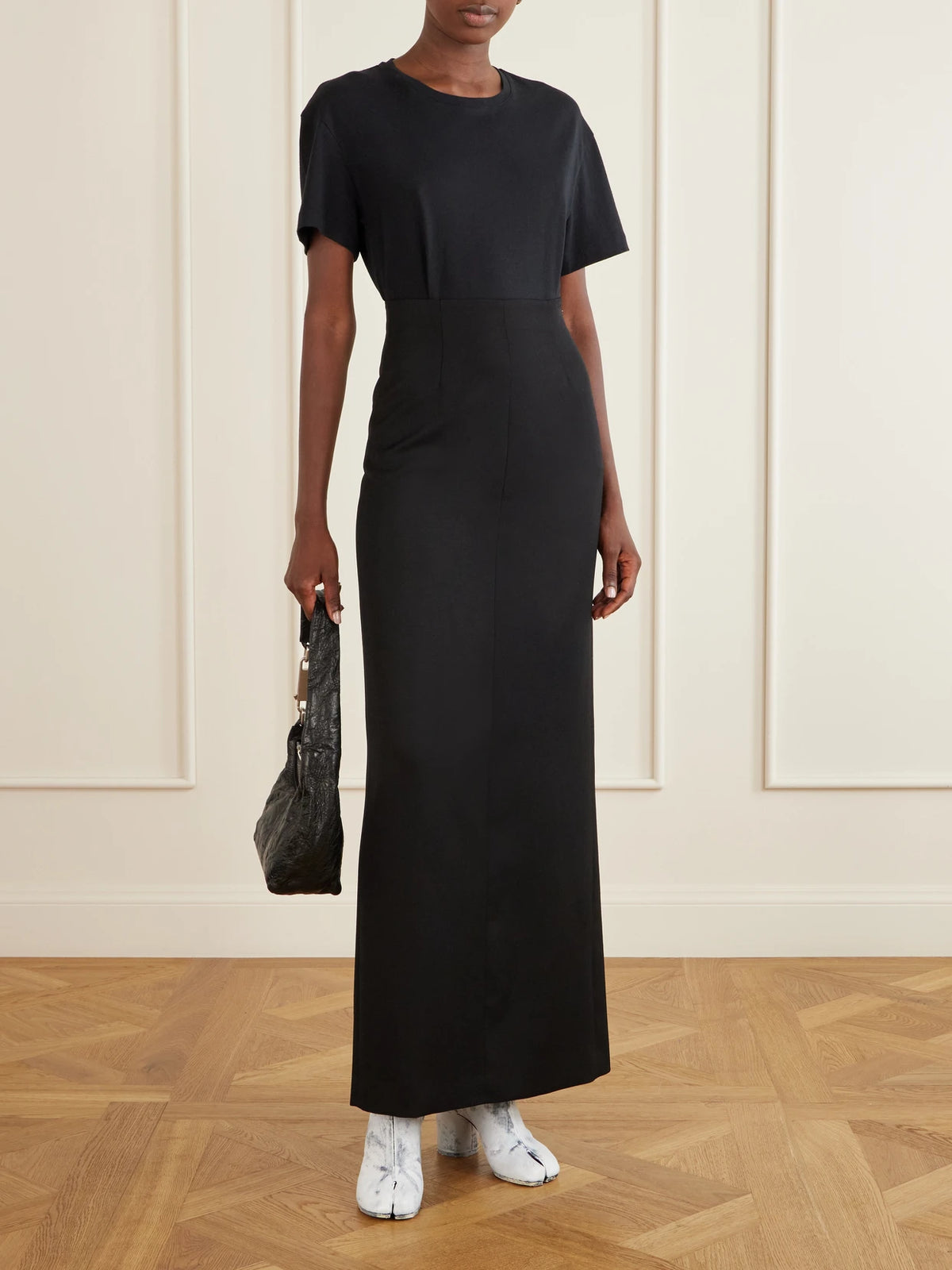 Image of a model wearing Skirts. Product name - Wool Maxi Skirt in Black colour by brand - Maison Margiela