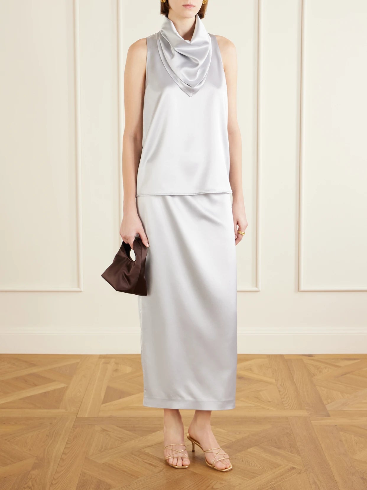 Image of a model wearing Skirts. Product name - Shea Satin Midi Skirt in Silver colour by brand - VIOLANTE NESSI