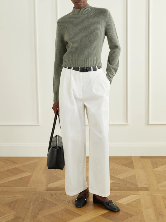 Image of a model wearing Outerwear. Product name - Chiba Ribbed Cropped Cashmere Turtleneck Sweater in Leaf green colour by brand - Le Kasha