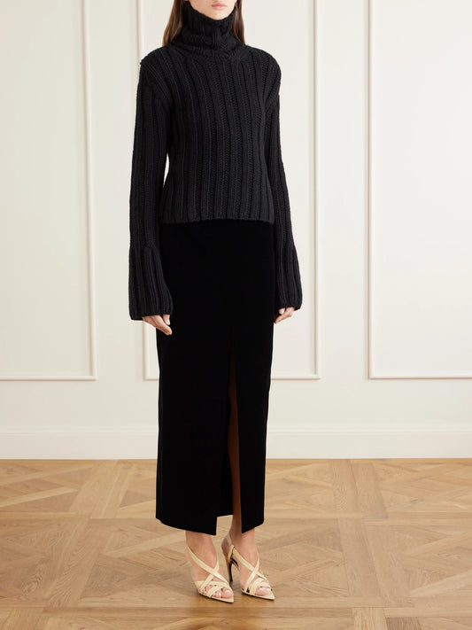 Image of a model wearing Outerwear. Product name - Kelly Ribbed Cashmere Turtleneck Sweater in Black colour by brand - KHAITE