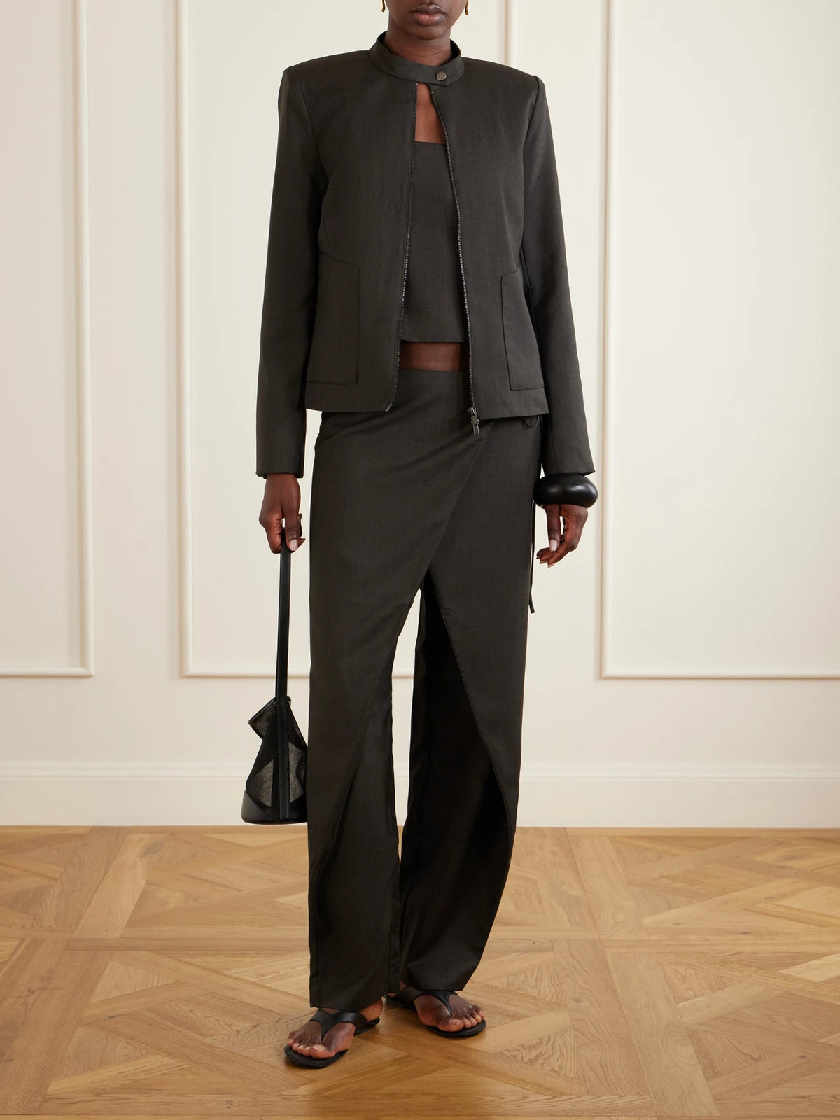Image of a model wearing Tops. Product name - Open-back Wool-blend Blouse in Anthracite colour by brand - ST. AGNI