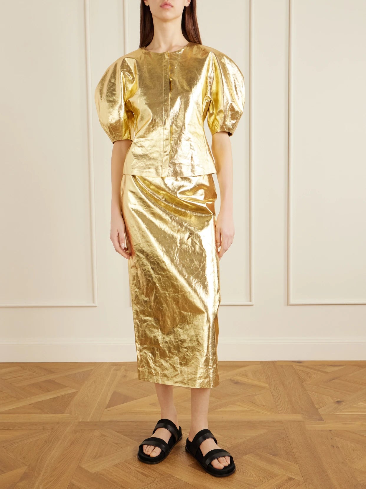 Image of a model wearing Skirts. Product name - Manuela Linen Midi Skirt in Gold colour by brand - Gabriela Hearst