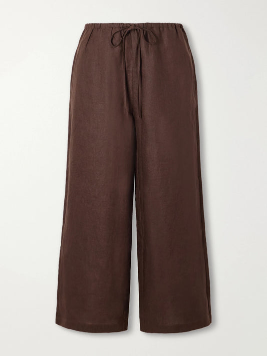 Image of a model wearing Pants. Product name - Mateo Linen Mid-rise Wide-leg Pants in Brown colour by brand - STAUD