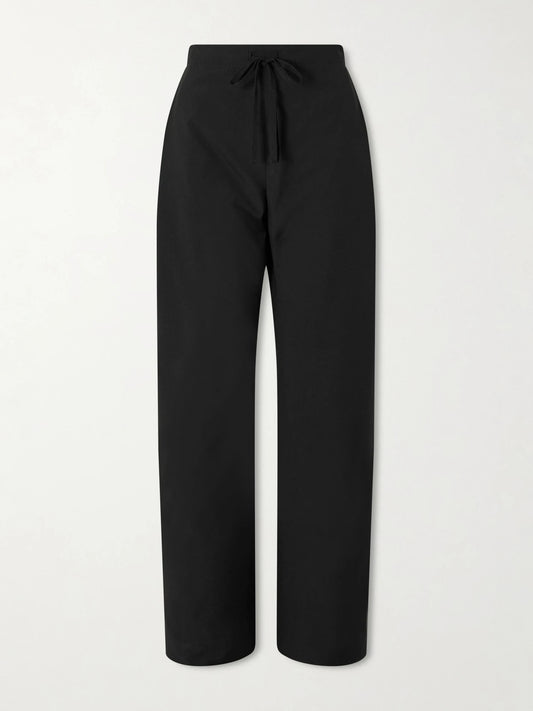 Image of a model wearing Pants. Product name - Rohen Wool Pants in Black colour by brand - KHAITE