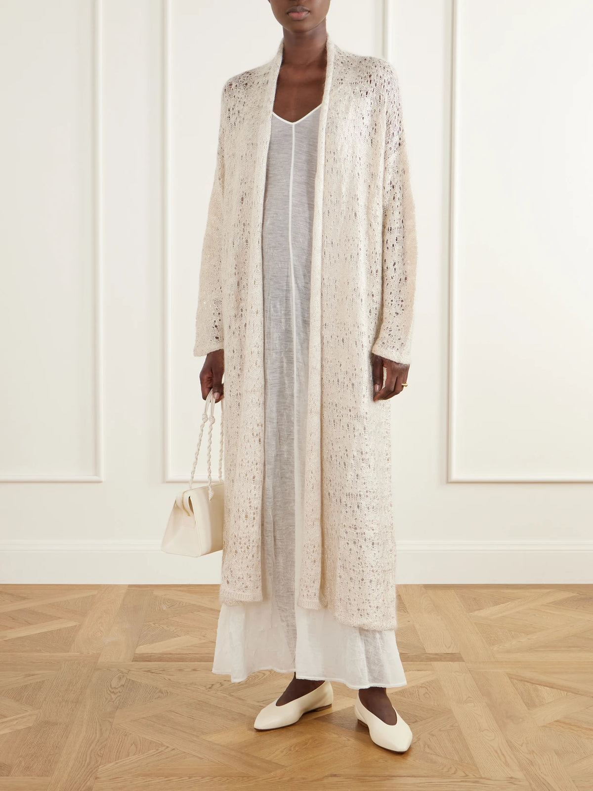 Image of a model wearing Outerwear. Product name - Evora Draped Open-knit Cardigan in Sand colour by brand - Ruohan