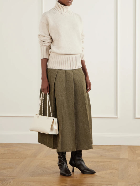 Image of a model wearing Skirts. Product name - Pleated Grain De Poudre Midi Skirt in Army green colour by brand - RÓHE