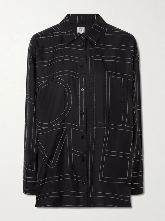 Image of a model wearing Tops. Product name - Embroidered Silk-twill Shirt in Black colour by brand - TOTEME