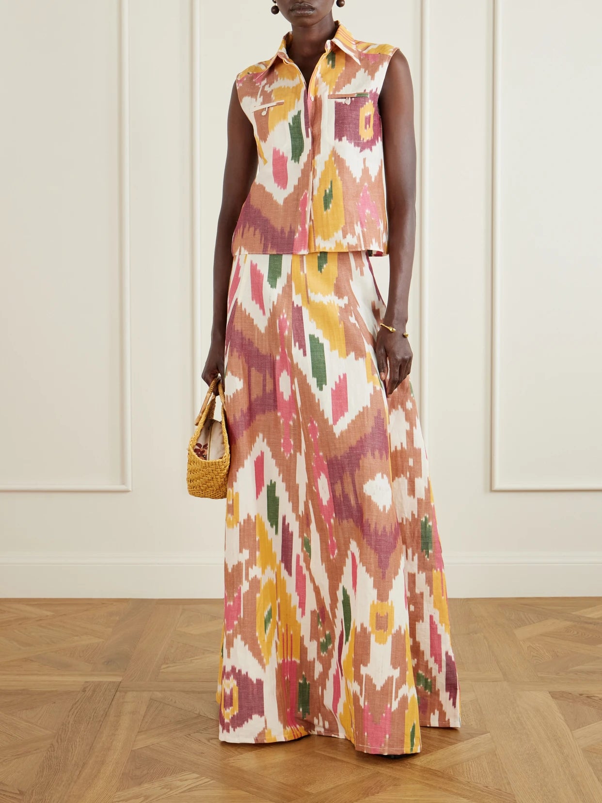 Image of a model wearing Skirts. Product name - Kika Printed Cotton And Linen-blend Maxi Skirt in Pink colour by brand - Emporio Sirenuse
