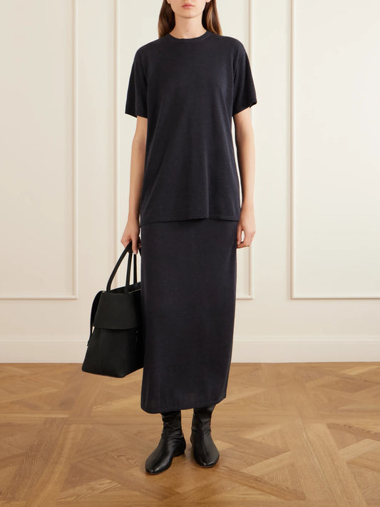 Image of a model wearing Skirts. Product name - Lyocell And Cashmere-blend Midi Skirt in Charcoal colour by brand - TOTEME