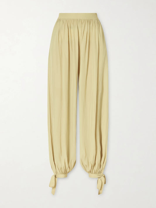 Image of a model wearing Pants. Product name - Satin Tapered Pants in Light green colour by brand - Chloé