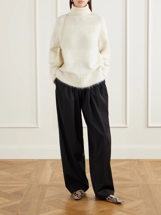 Image of a model wearing Outerwear. Product name - Mila Brushed Knitted Turtleneck Sweater in Ivory colour by brand - Joseph