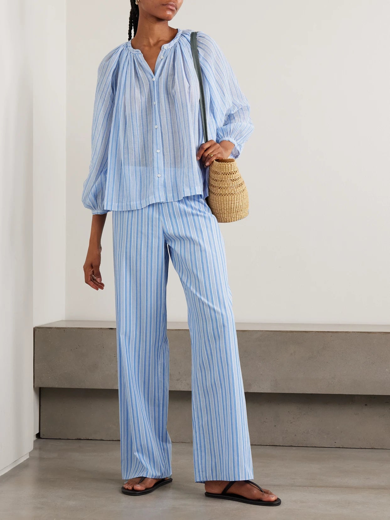 Image of a model wearing Tops. Product name - Jonie Striped Organic Cotton-voile Blouse in Blue colour by brand - DÔEN