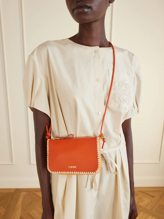 Image of Bags. Product name - + Paula's Ibiza Rio Raffia-trimmed Leather Shoulder Bag in Bright orange colour by brand - LOEWE