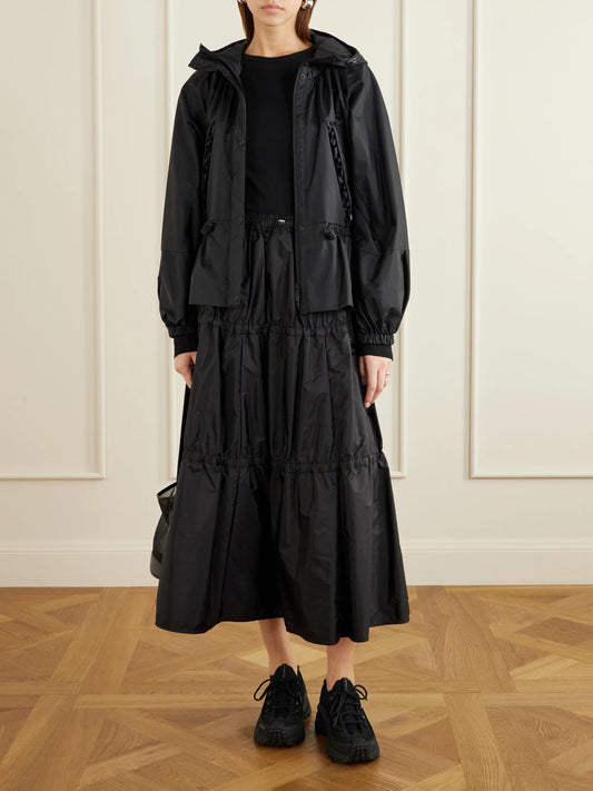 Image of a model wearing Skirts. Product name - Tiered Shell Midi Skirt in Black colour by brand - Moncler