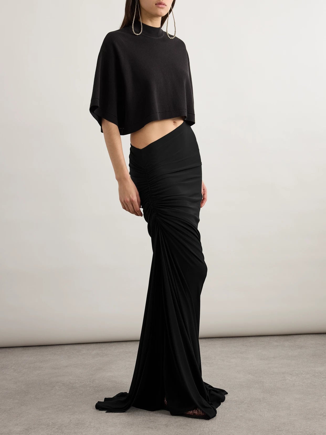 Image of a model wearing Skirts. Product name - Draped Stretch-knit Maxi Skirt in Black colour by brand - Alaïa