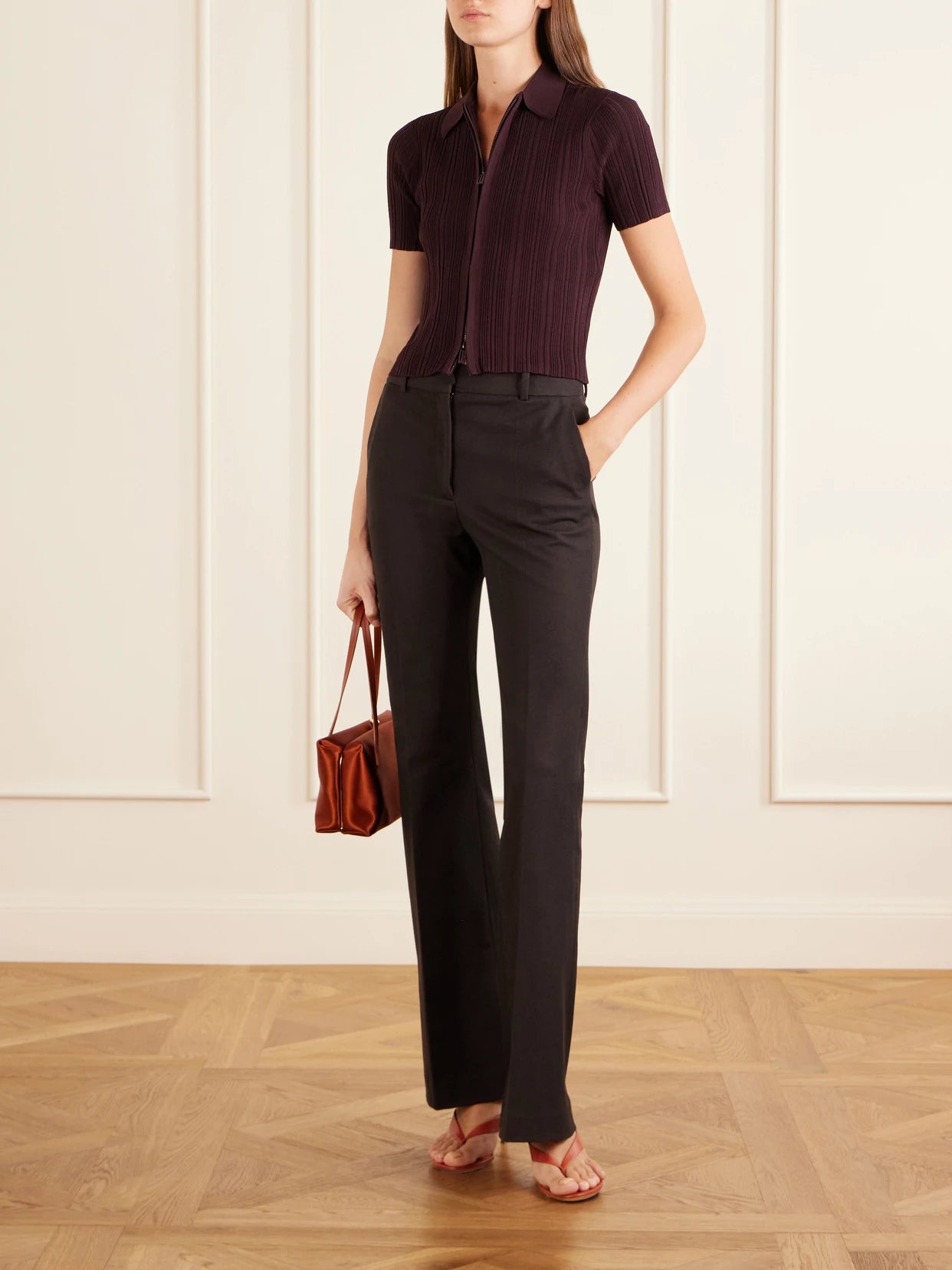 Image of a model wearing Outerwear. Product name - Ribbed Polo Top in Burgundy colour by brand - Victoria Beckham