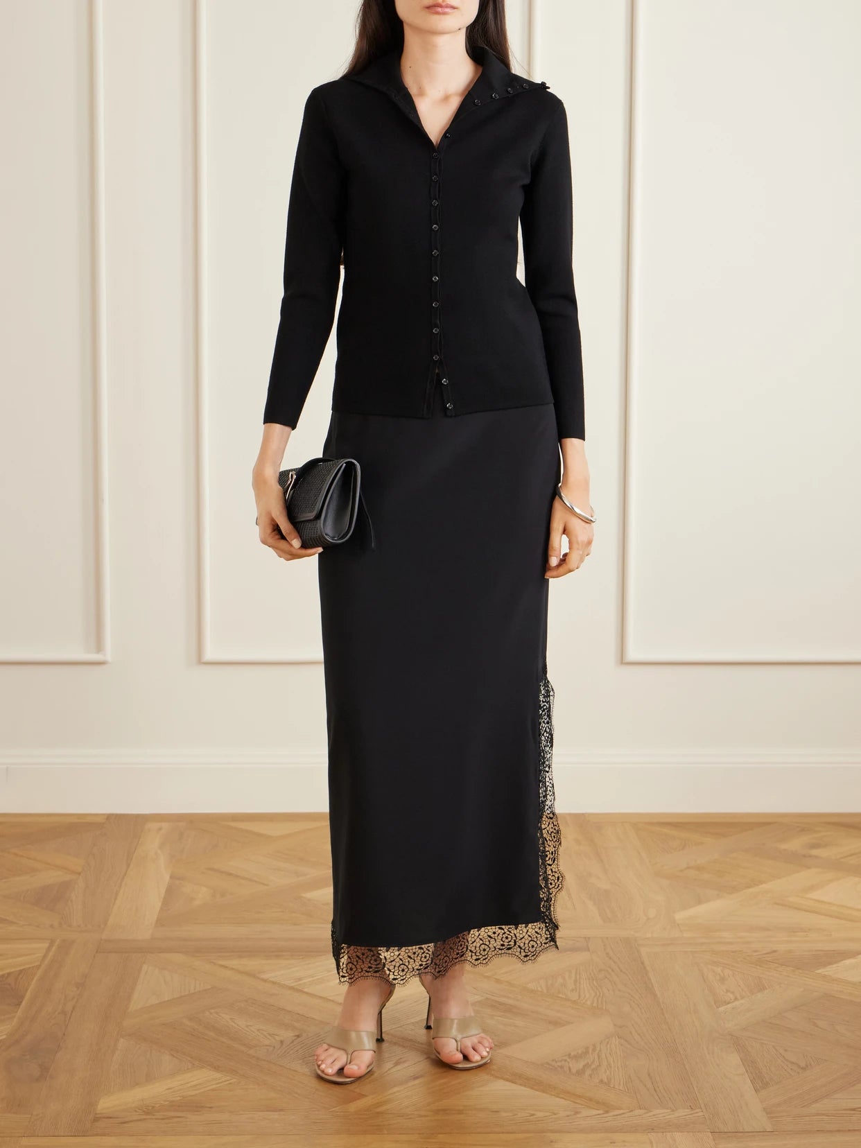 Image of a model wearing Skirts. Product name - Phoenix Lace-trimmed Silk-blend Midi Skirt in Black colour by brand - La Ligne