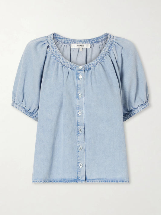 Image of a model wearing Tops. Product name - The Resort Cotton And Lyocell-blend Chambray Blouse in Blue colour by brand - FRAME